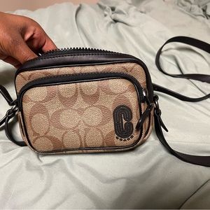 Brown Coach cross body purse.